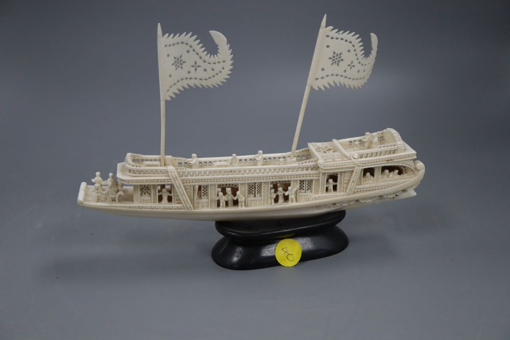 A Chinese carved ivory boat, on stand, length 23cm